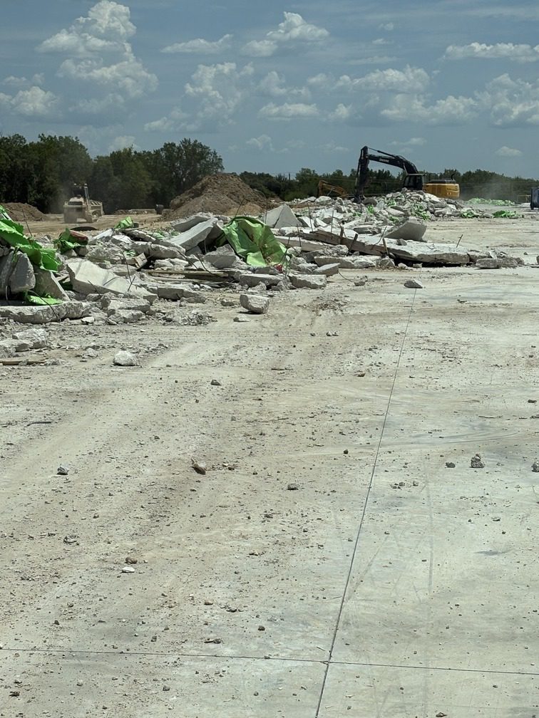 How DeCrowder Demo Successfully Removed a 77,000 Sqft Concrete Slab 1 a construction site with concrete and debris